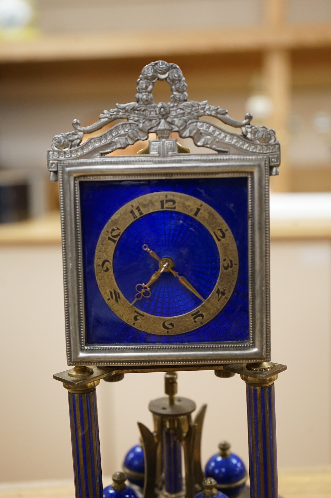 A Jahresuhrenfabrik anniversary clock with blue-enamelled dial, under glass dome, 32cm